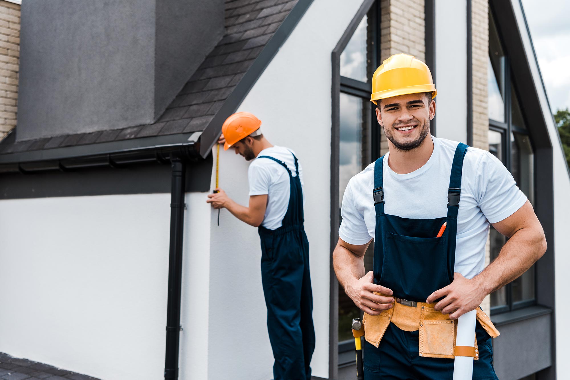 selective-focus-of-happy-handyman-in-uniform-near-service